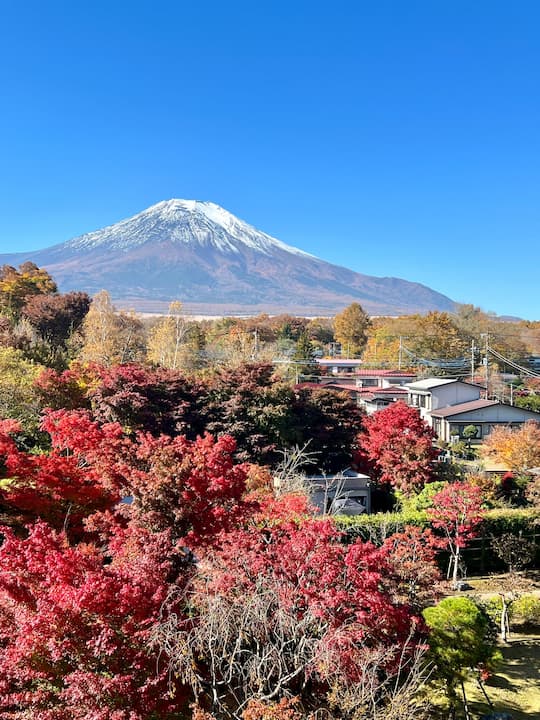 Serene scene of Fuji Matsuzono Hotel set against Mount Fuji, resembling a painting