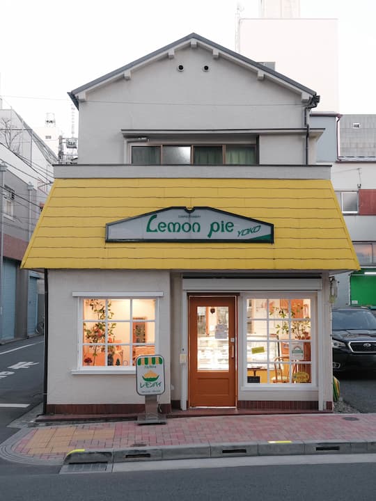 Interior of Yogashi Lemon Pie cafe with warm yellow decor and lemon-themed elements