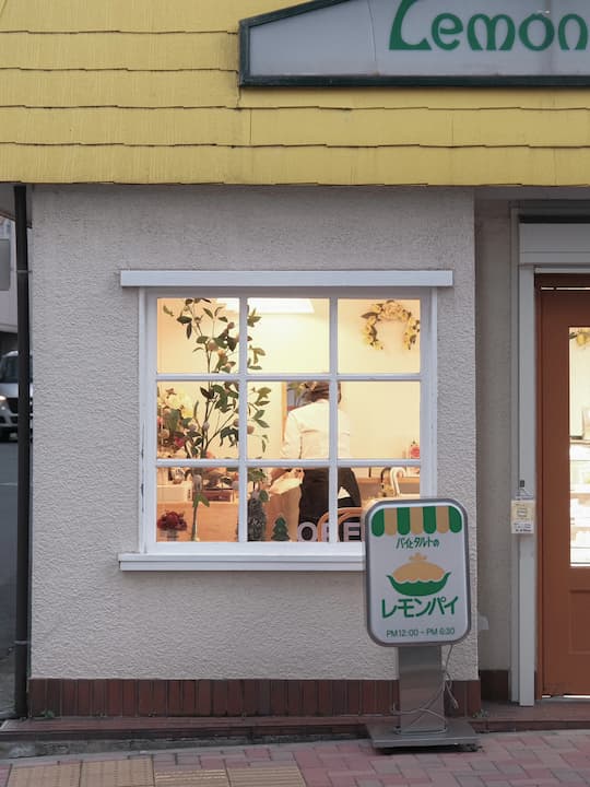 Interior of Yogashi Lemon Pie cafe with warm yellow decor and lemon-themed elements.