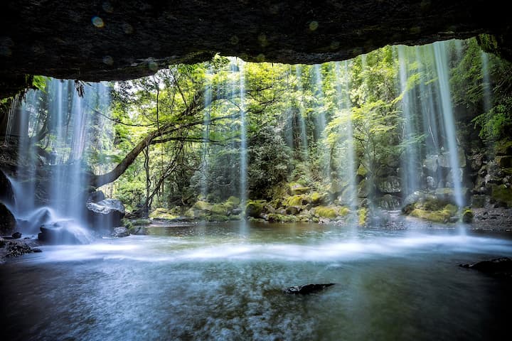 Hidden cave behind Nabegataki Falls in Kumamoto, Japan