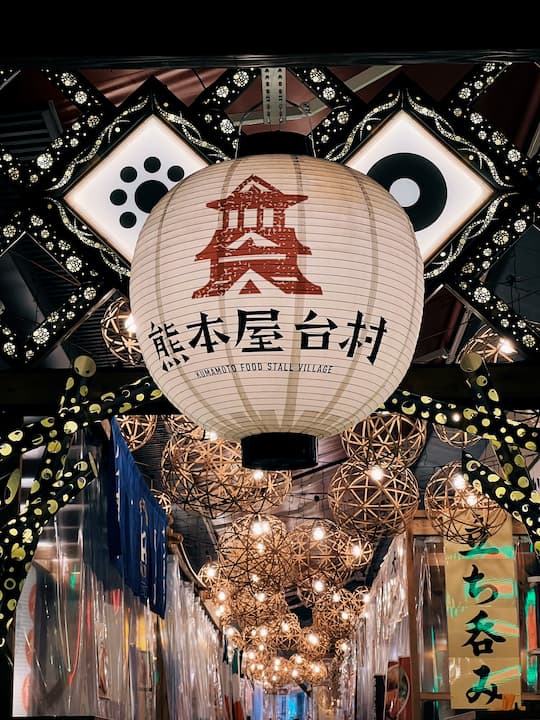 Vibrant scene at Kumamoto Food Stall Village at night in Kumamoto, Japan