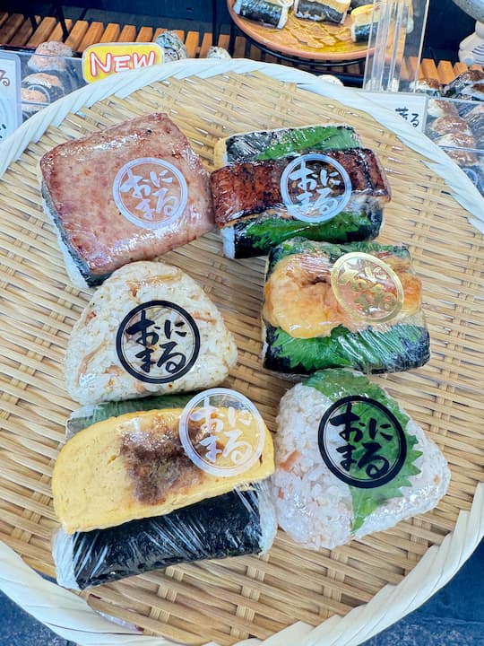 Freshly made onigiri rice balls at Onimaru Kyoto in Kyoto, highlighting the variety and freshness of each creation.