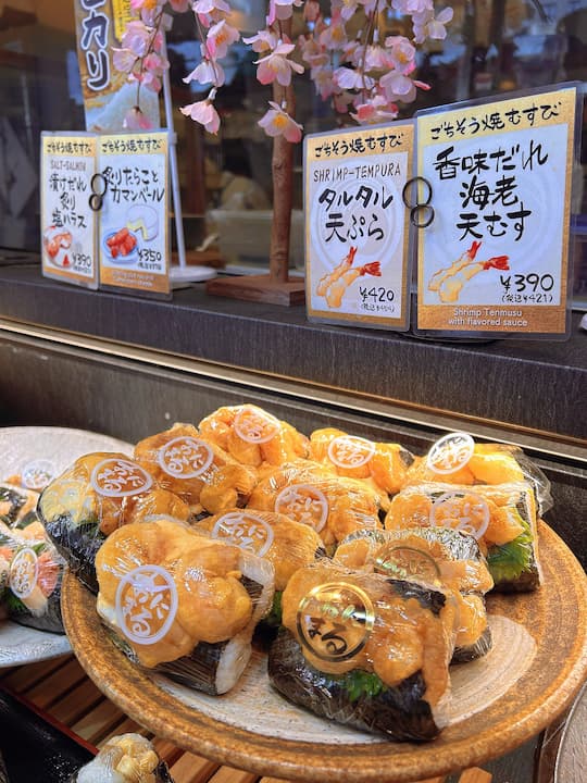 Close-up of onigiri made with high-quality Koshihikari rice at KYOTO ONIMARU onigiri shop, showing full grains and firm texture