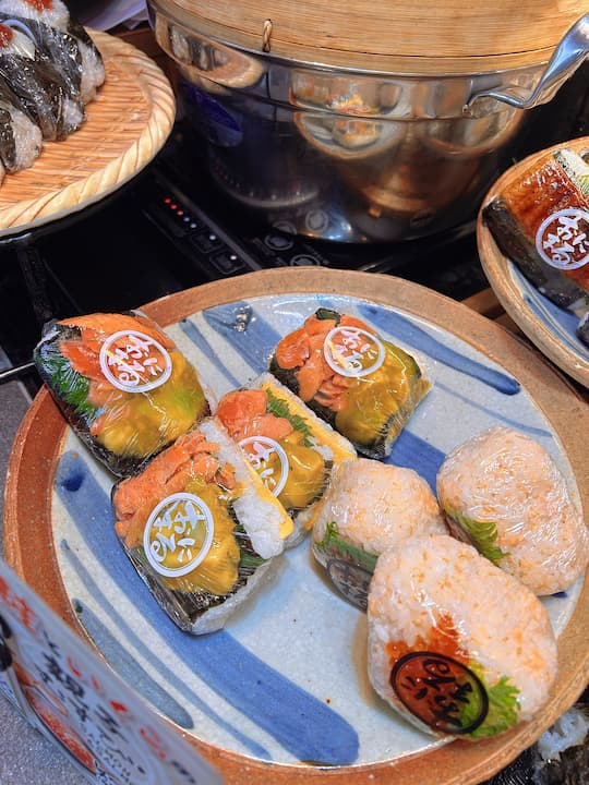 Close-up of onigiri made with high-quality Koshihikari rice at KYOTO ONIMARU onigiri shop, highlighting the grain quality and texture