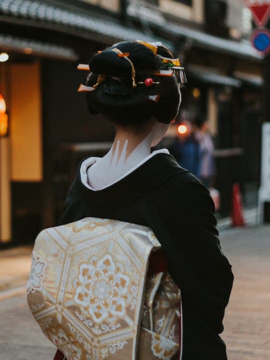 A quiet street in Hanamikoji Street, frequented by geishas, leading towards the Kamo River