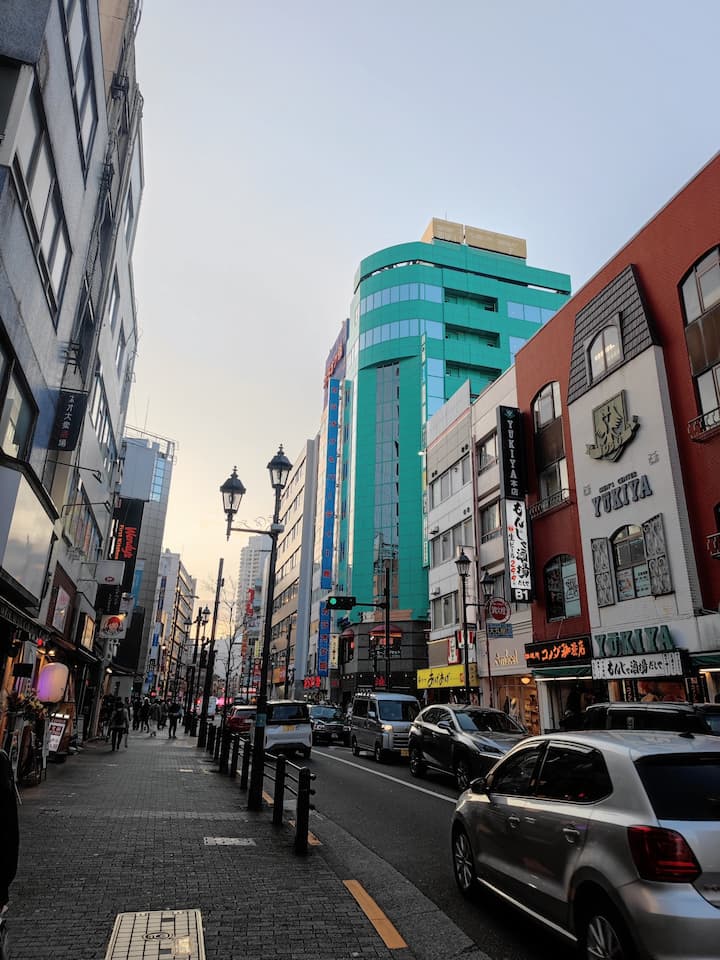 Ikebukuro's bustling shopping area with large malls and vibrant street scene near the west exit