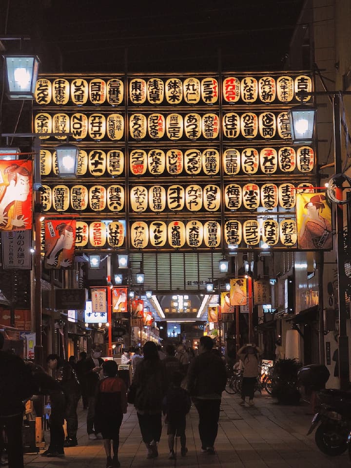 Lively shopping street near Sensō-ji Temple, featuring traditional snacks, souvenirs, and handicrafts