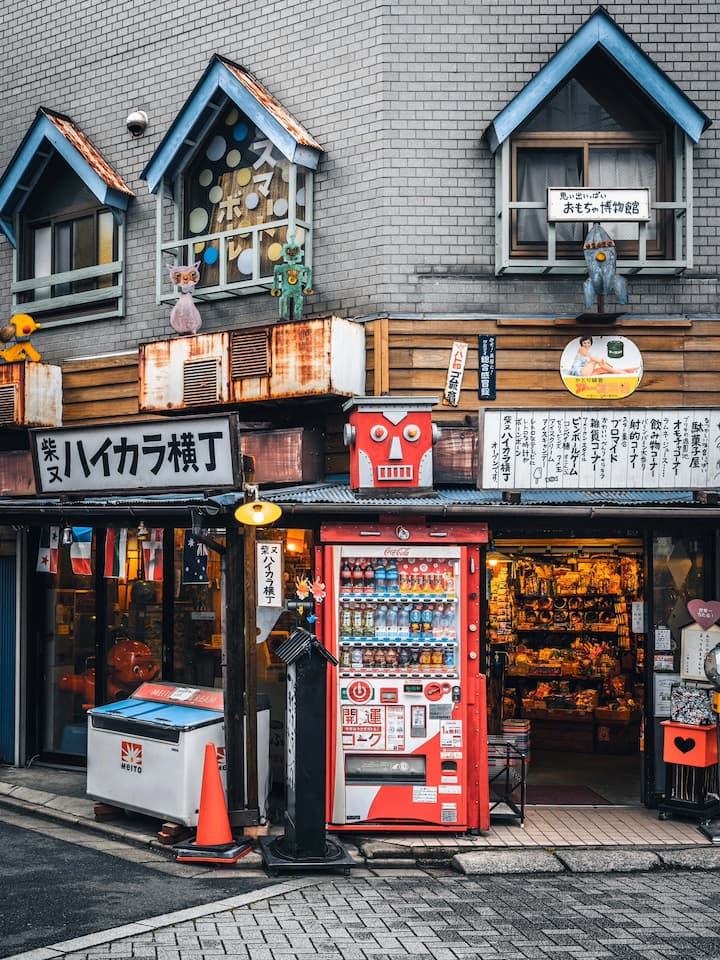 Vintage candy shop in Shibamata with old Japanese snacks and toys displayed, including black-and-white TVs and retro gaming consoles