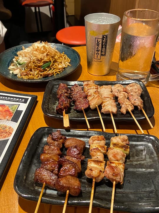 Grilled chicken skewers and fried noodles at Yakitori Yarou Shinjuku